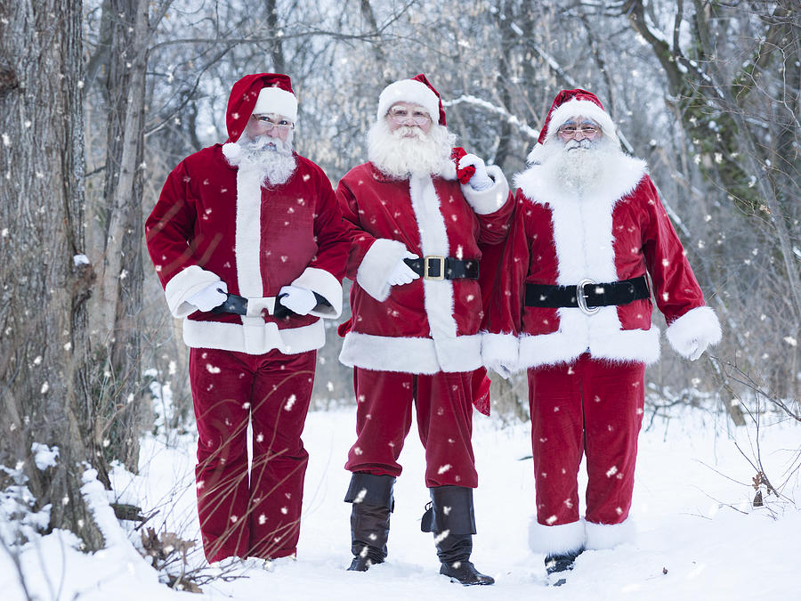 Santas at forest delivering presents #1 Photograph by Vesnaandjic