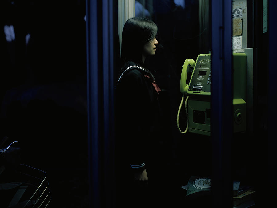 School girl in a public telephone booth #1 Photograph by Dex Image