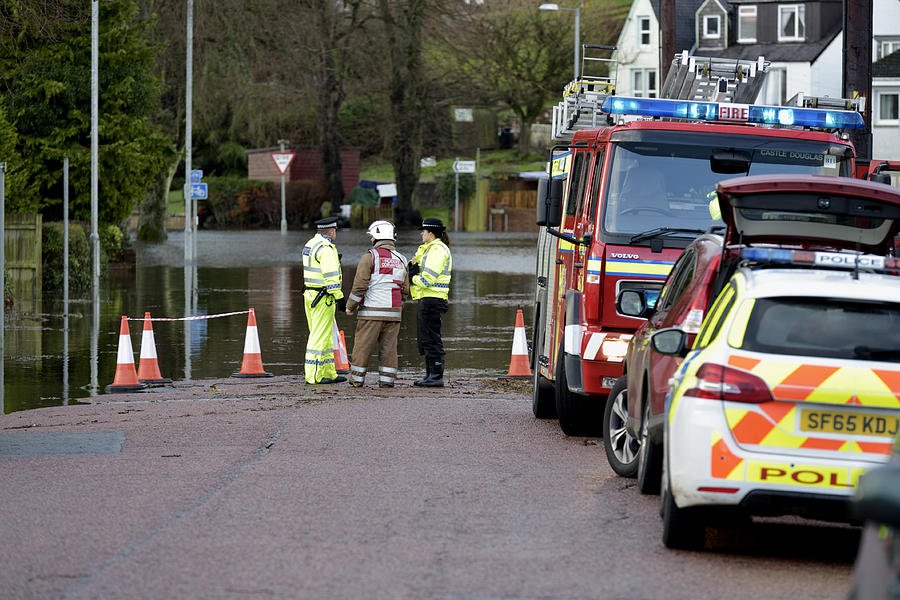 Scottish fire brigade personnel and police attending a flood #1 Photograph by JohnFScott