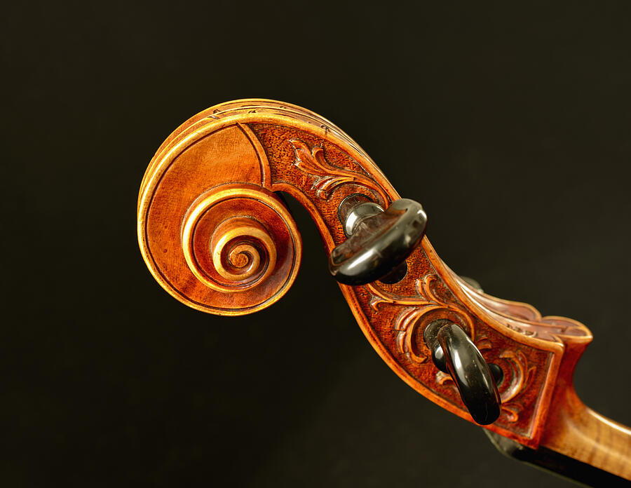 Scroll of cello against black background, close up #1 Photograph by Westend61