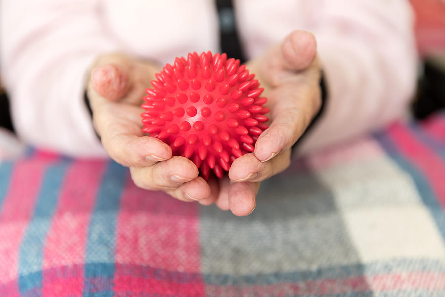 Senior hand with massage ball #1 Photograph by FredFroese