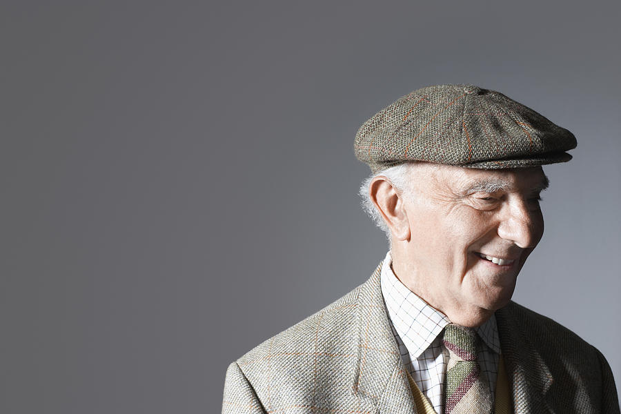 Senior man in flat cap, head and shoulders, in studio #1 Photograph by Moodboard