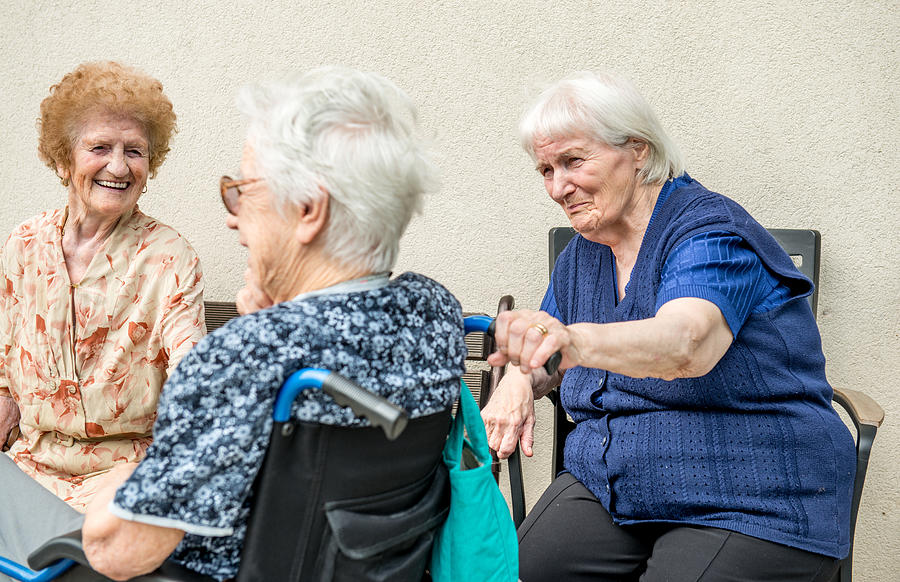 Senior Woman In The Retirement Home Socializing Outdoor #1 Photograph by CasarsaGuru