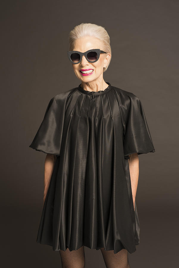 Senior woman with sunglasses and black satin dress #1 Photograph by Compassionate Eye Foundation