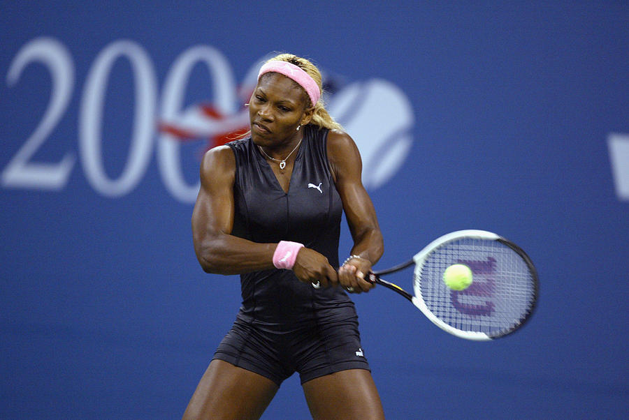 Serena Williams returns a shot  #1 Photograph by Al Bello