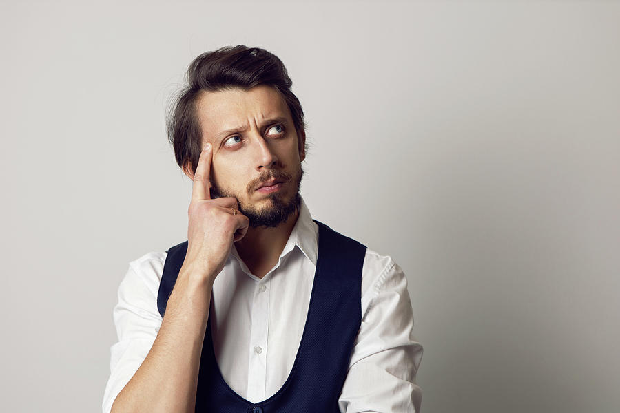 Serious Portrait Of A Man In A Vest In A White Shirt On A White ...