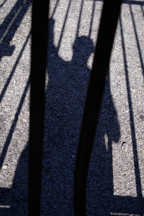 Shadow of man behind bars #1 Photograph by Sami Sarkis