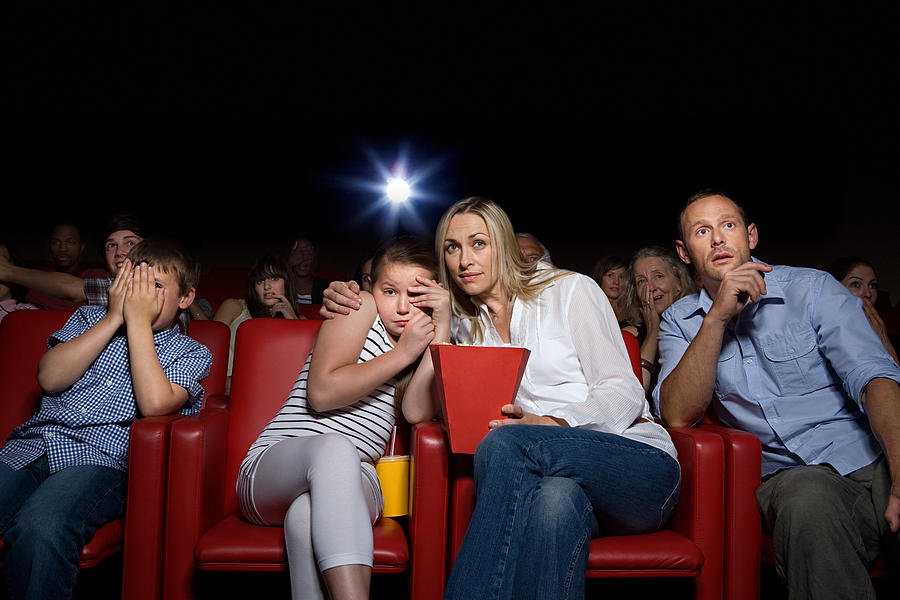 Shocked family in movie theater #1 Photograph by Image Source