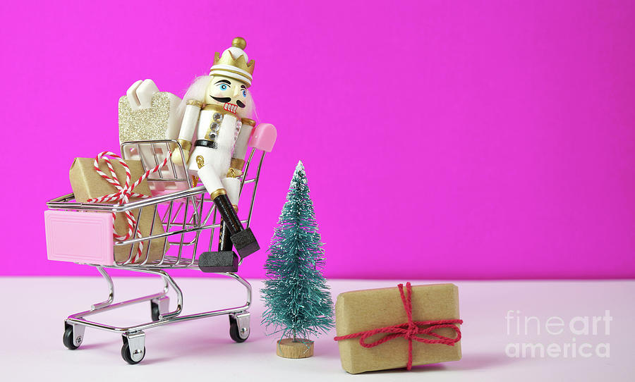 Shopping cart full of Christmas gifts, tree and nutcracker ornament. #1 Photograph by Milleflore Images