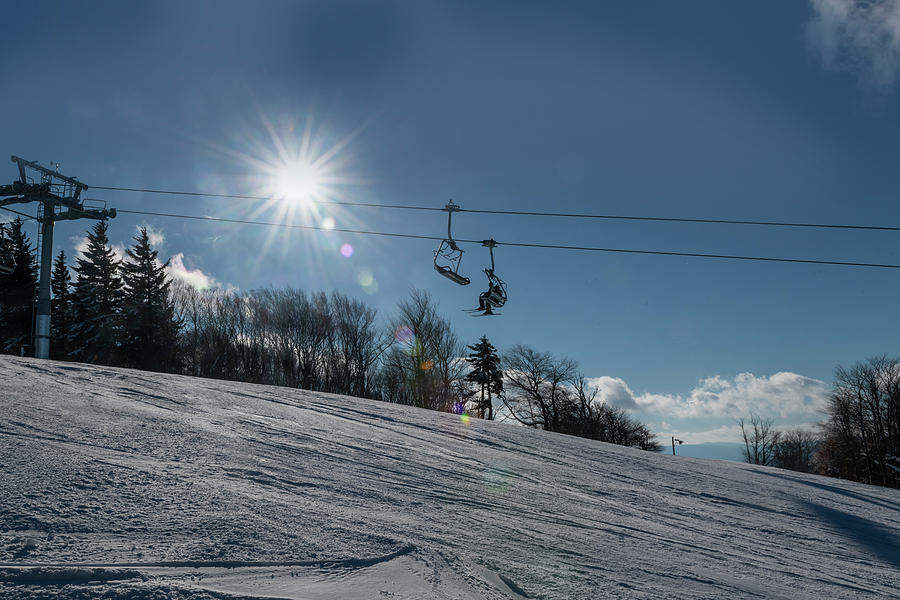 Ski lift with sunburst on winter day Photograph by Dan Friend