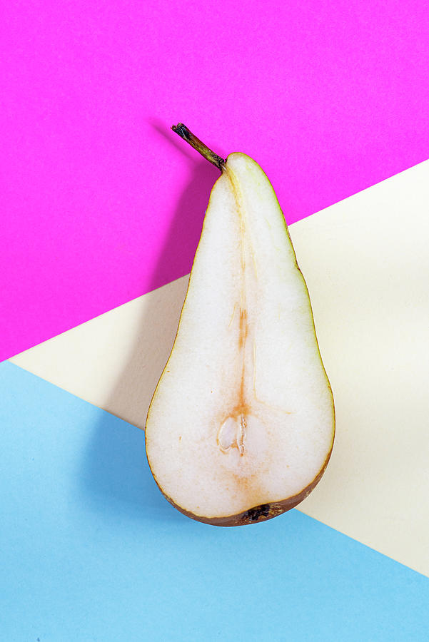 Slice of healthy pear fruit on a colourful background. Photograph by Michalakis Ppalis