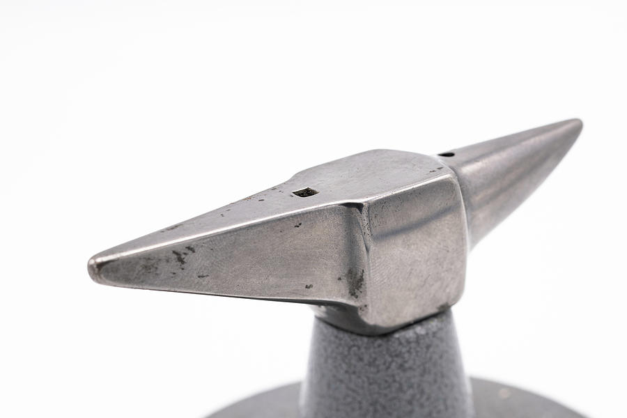 Small anvil in front of white background #1 Photograph by Stefan
