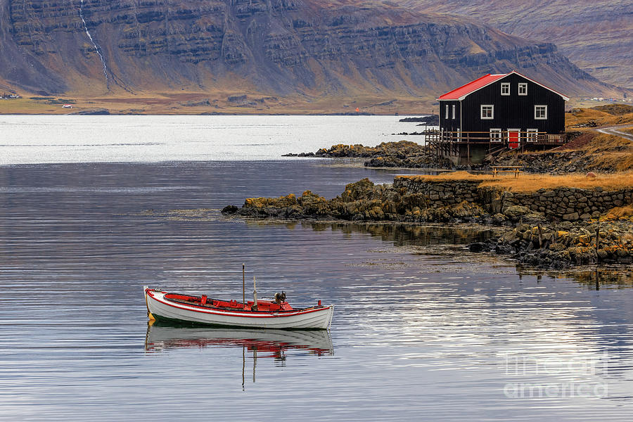 Small boat and black wooden house, Djupivogur, Eastfjords, Icela #1 Photograph by Jane Rix