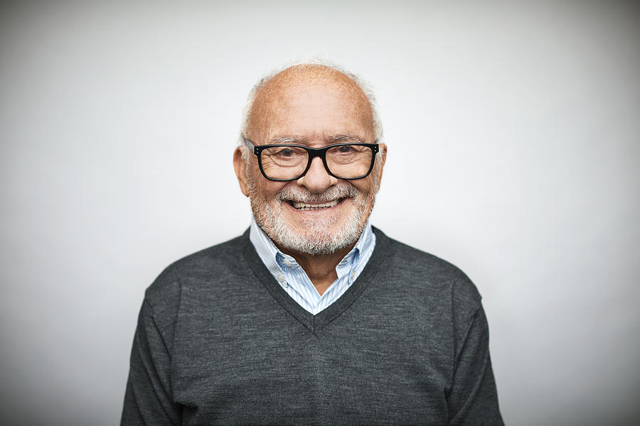 Smiling senior businessman on white background #1 Photograph by Morsa Images
