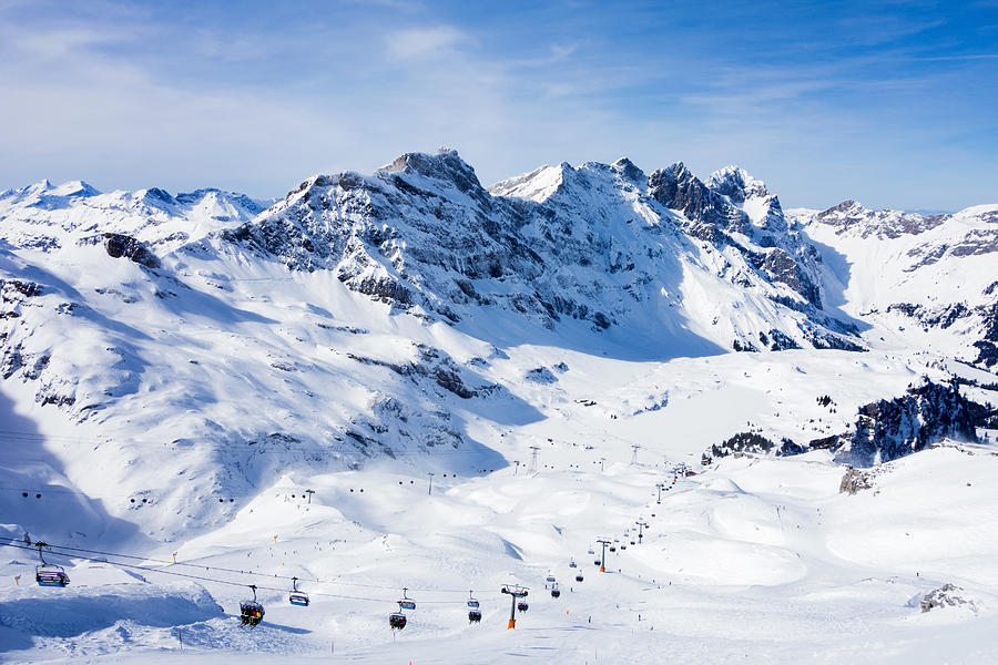 Snow covered mountain landscape and ski lift, Engelberg, Mount Titlis, Switzerland #1 Photograph by Francesco Meroni