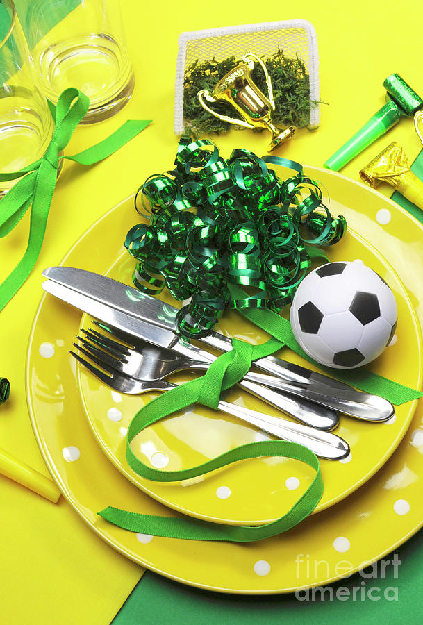 Soccer football celebration party table settings in yellow and green team colors. #1 Photograph by Milleflore Images