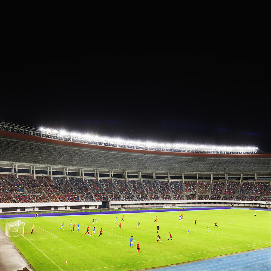 Soccer game in a stadium at night #1 Photograph by Shannon Fagan