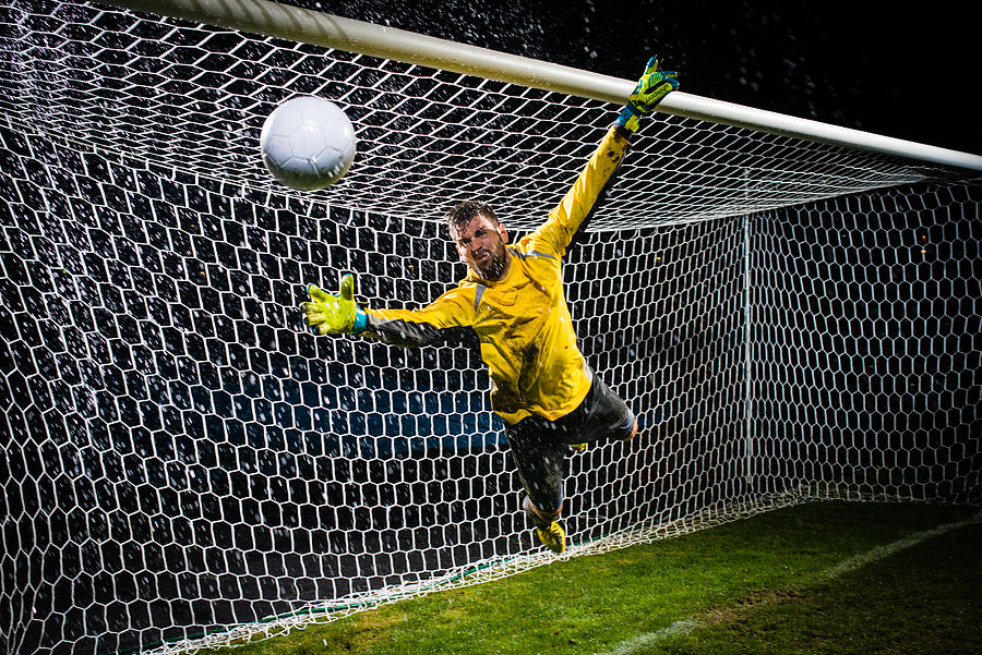 Soccer Goalie Jumping For Ball #1 Photograph by Simonkr