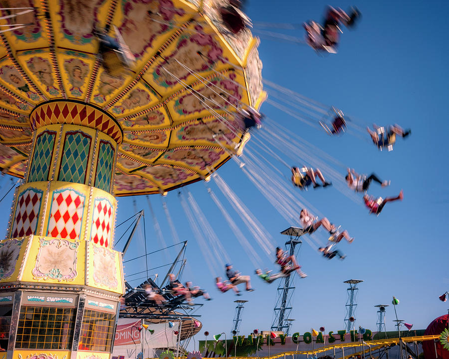 Spinning Carousel with people Photograph by David May