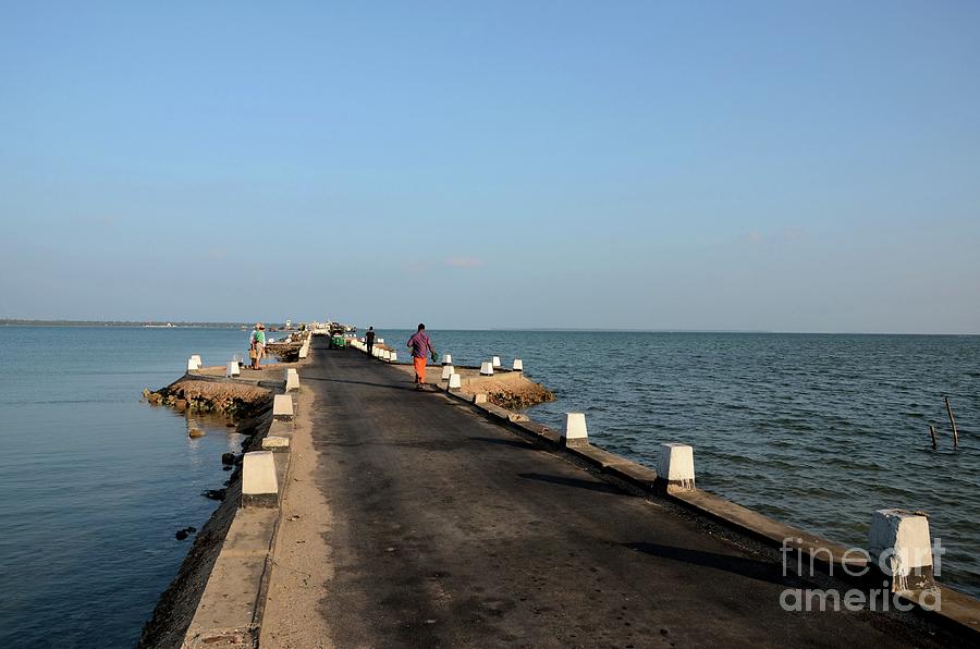 Bridge Photograph - Sri Lankans walk on a causeway road out towards a jetty in water Jaffna Sri Lanka #3 by Imran Ahmed