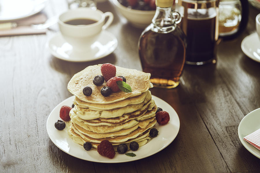 Stack of Pancakes with Maple Syrup, Berries and Fresh Coffee #1 Photograph by GMVozd