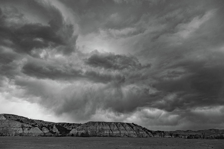 Storm clouds over mountain at Theodore Roosevelt National Park in North Dakota in black and white #1 Photograph by Eldon McGraw