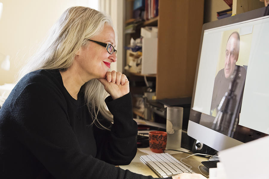 Stylish 50+ woman in video conference working from home. #1 Photograph by Martinedoucet