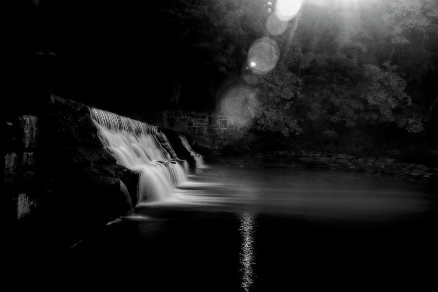 Sunburst at dam on river    Black and White #1 Photograph by Dan Friend