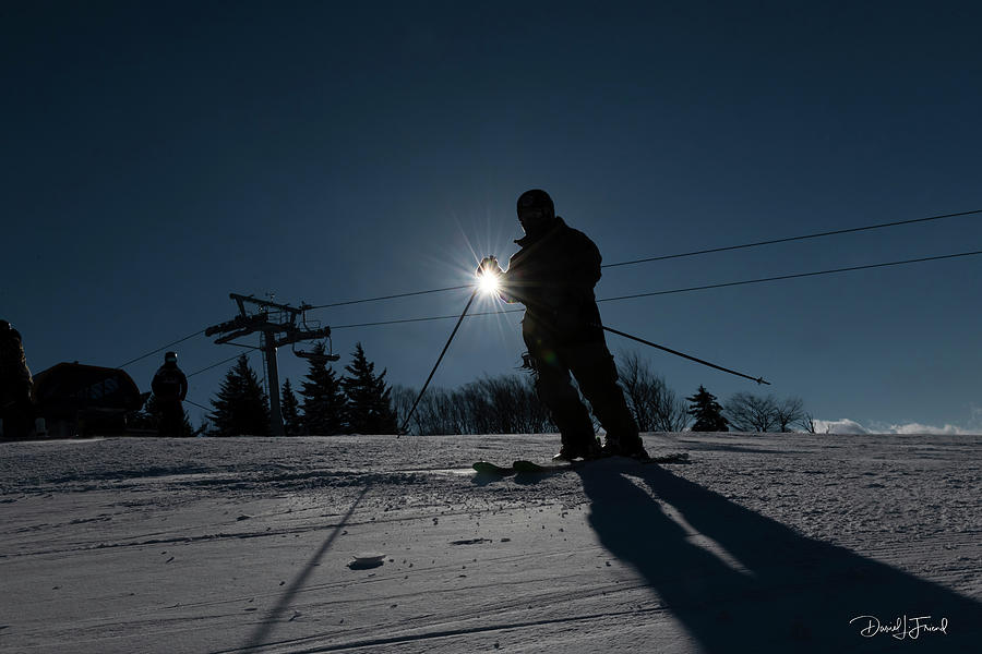 Sunburst with skier making a silhouette Photograph by Dan Friend