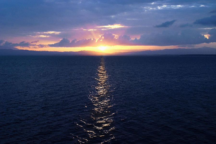Sunset over the sea, Milne Bay, Papua New Guinea #1 Photograph by Glowimages