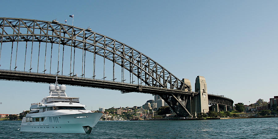 Super luxury 45mtr motor yacht passing under Sydney Harbour Brid #1 Photograph by Geoff Childs
