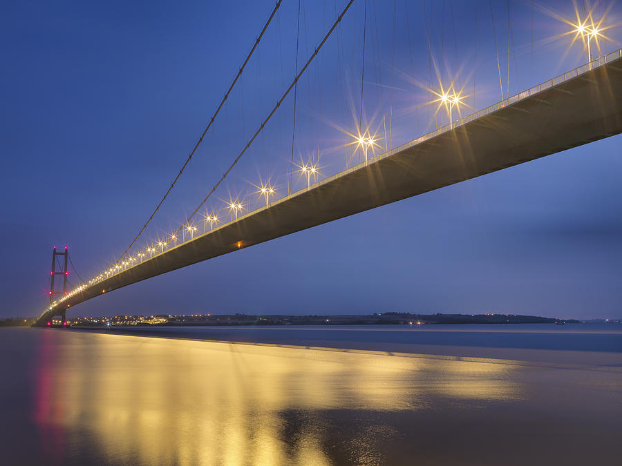Suspension bridge at night. The Humber Bridge, UK was built in 1981 and at the time was the worlds largest single-span suspension bridge #1 Photograph by Monty Rakusen