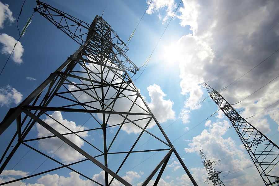 Tall Electric Masts Against Sun And Sky Photograph by Mikhail ...