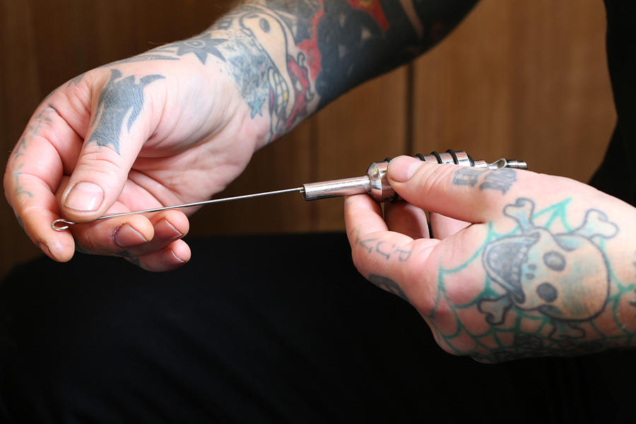 Tattoo artist, preparing tattoo ink gun #1 Photograph by Nicola Tree