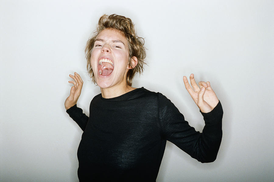 Teenage boy screaming, close up #1 Photograph by David De Lossy