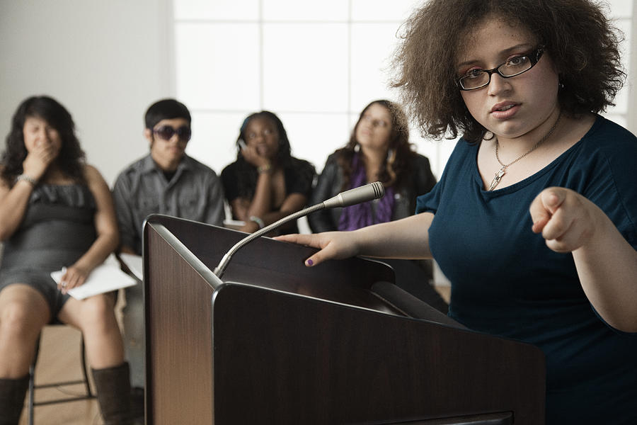 Teenage girl giving speech to classmates #1 Photograph by Hill Street Studios