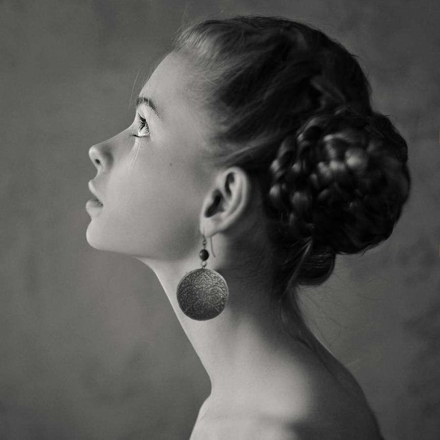 Teenage girl with braided hair wearing dangling earrings #1 Photograph by Vladimir Serov