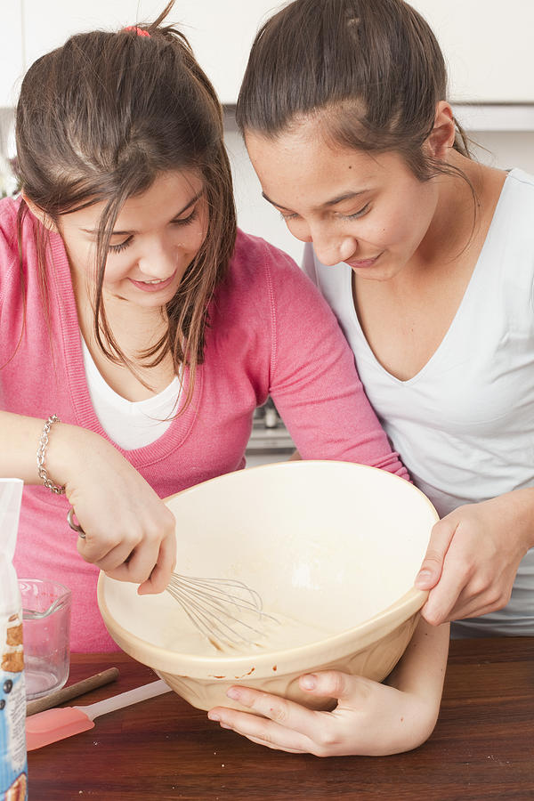 Teenage Girls Preparing Food In Kitchen #1 Photograph by Tim Hall