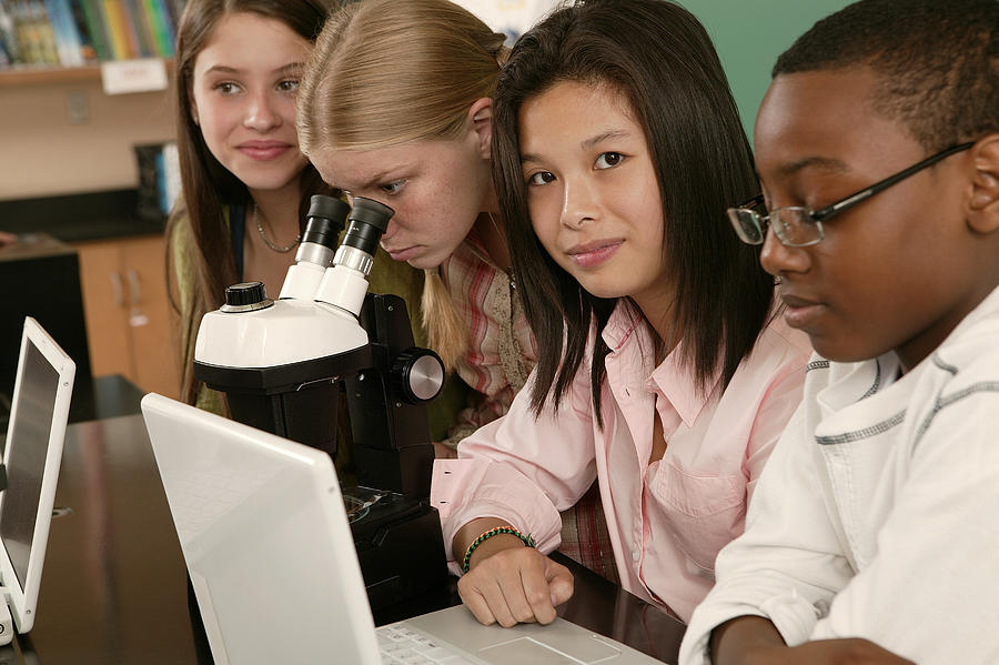Teenagers at school with laptop computer and microscope #1 Photograph by Comstock Images