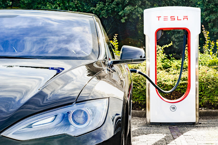 Tesla Model S electric car at a supercharger charging station #1 Photograph by Sjo