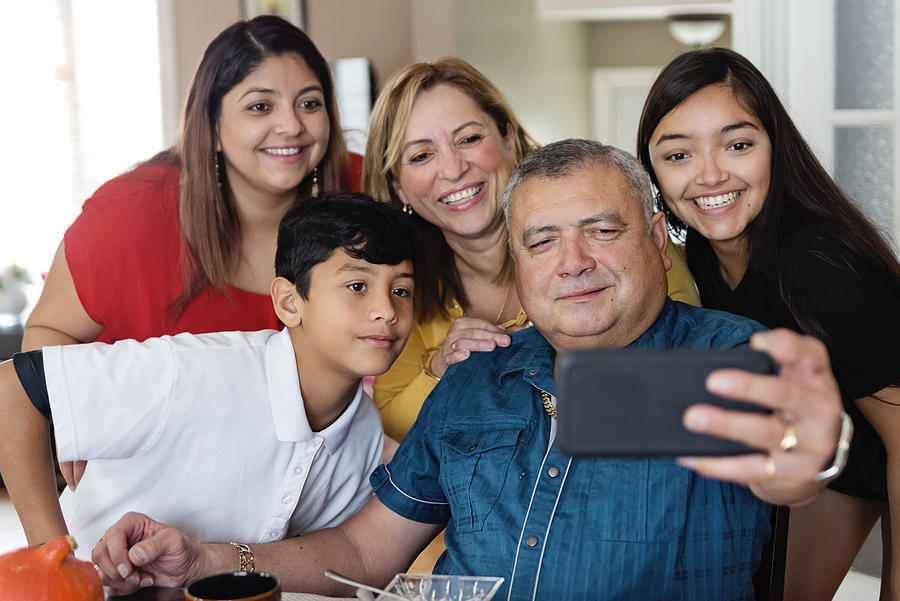 Three generations Latin American family taking selfie at meal time. #1 Photograph by Martinedoucet