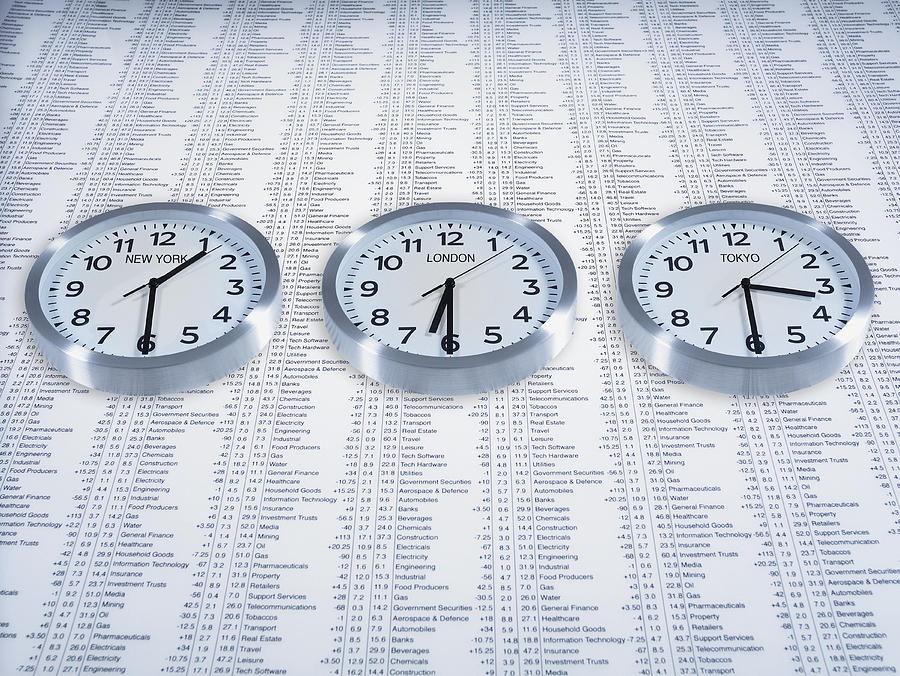 Time zone clocks on list of share prices #1 Photograph by Adam Gault