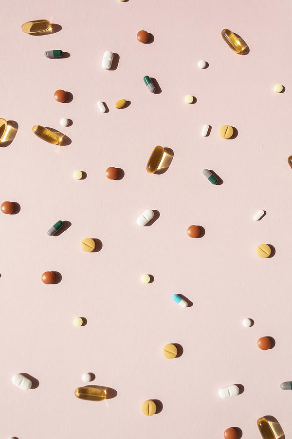 Top view of various pills and tablets on the pink background #1 Photograph by Yulia Reznikov