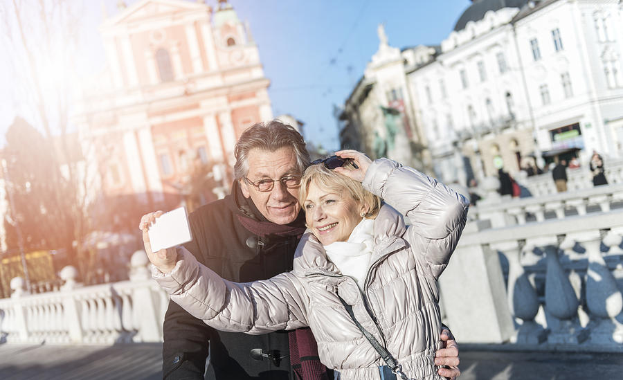 Tourist couple taking a selfie in Ljubljana, Slovenia #1 Photograph by Vitranc