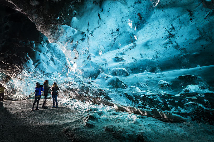 Tourists in The Crystal Cave, Breidamerkurjokull Glacier, Iceland #1 Photograph by Arctic-Images