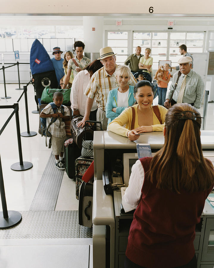 Tourists Queuing at an Airport Check-in #1 Photograph by Digital Vision.