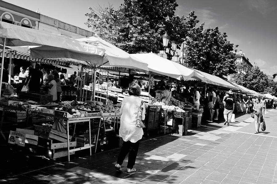 Tourists walking past market stalls. #1 Photograph by Alphotographic