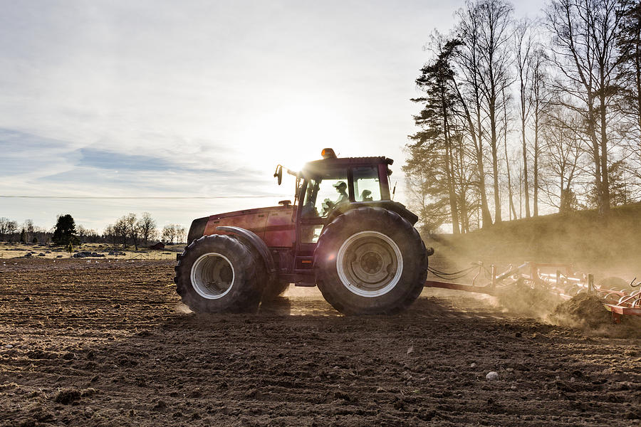Tractor plowing field #1 Photograph by Johner Images