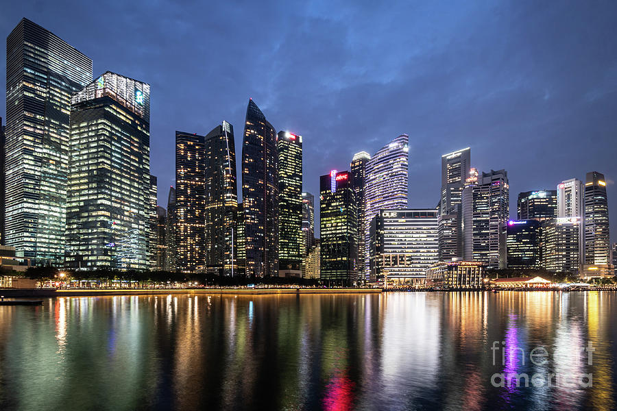 Twilight over the famous Singapore business district skyline by  #1 Photograph by Didier Marti