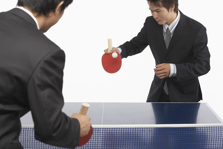 Two businessmen playing table tennis #1 Photograph by Sean Justice